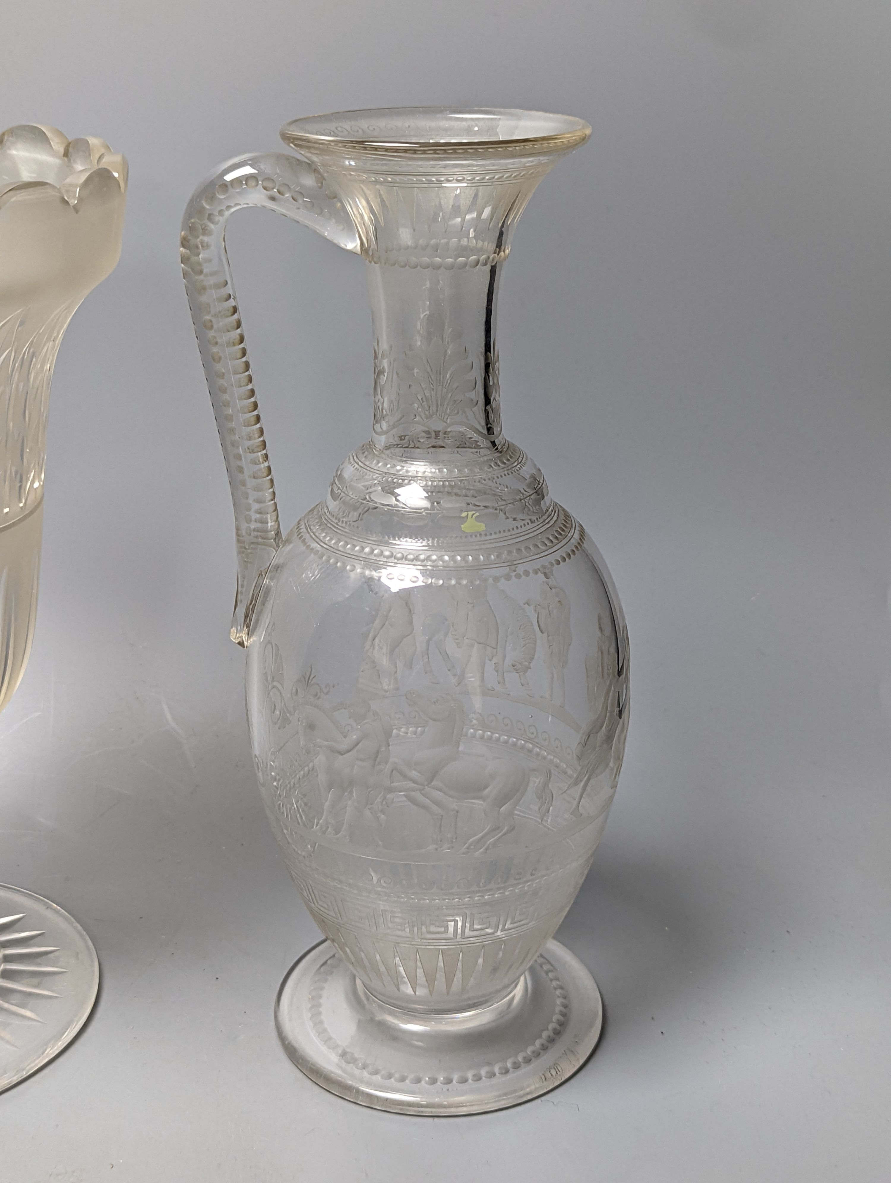 A Victorian wheel engraved ewer,with quinine scenes after the antique, 26 cms high, including 3 celery vases and a decanter.